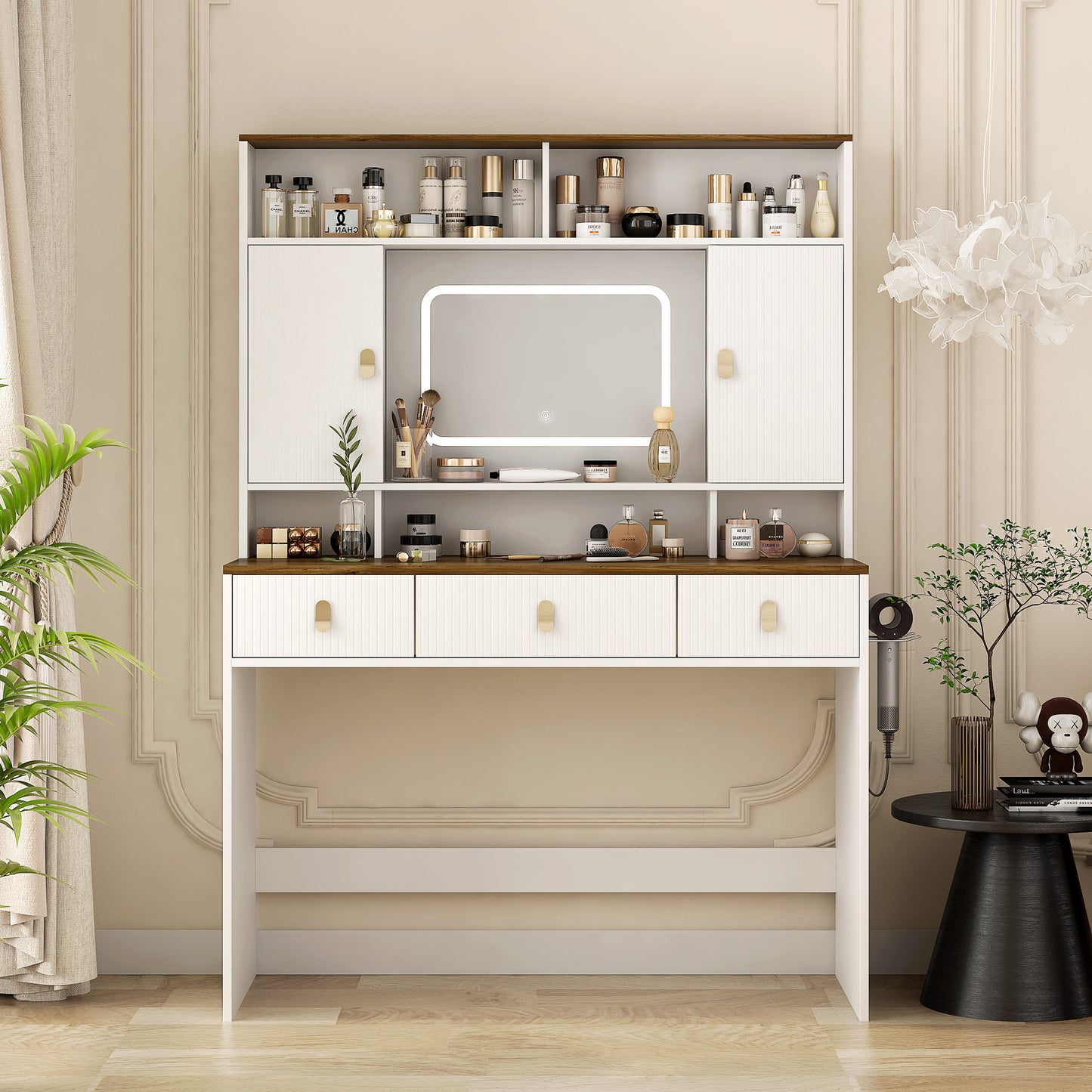 A white farmhouse style dressing table with a built-in LED-lit mirror, multiple drawers, and a shelf with various cosmetics displayed. It also shows a coordinating upholstered stool.