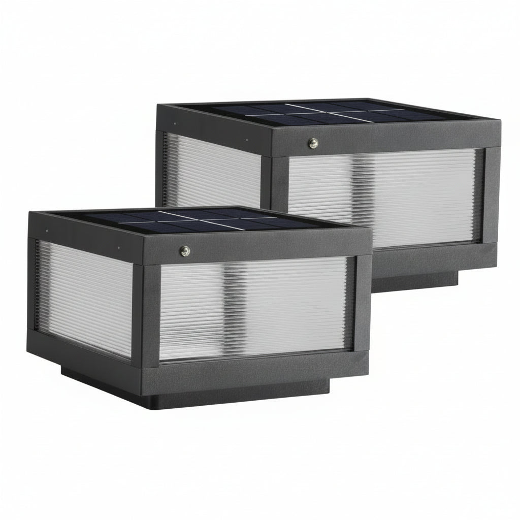 Two solar wall lights mounted on a brick column near the entrance of a house with a dark roof and a tree with red leaves in the background.