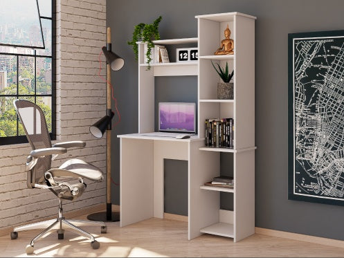 A white five-shelf desk with a computer set up on it, featuring a spacious desktop, positioned in a room with a chair and wall decorations in the background.