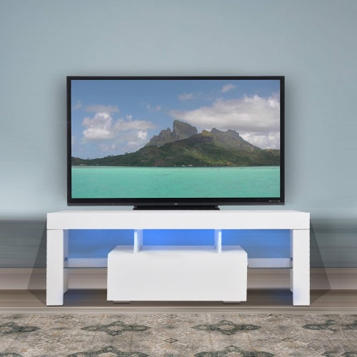 A modern white TV stand with storage drawer and LED lighting, featuring a flat-screen TV on top displaying a nature scene.