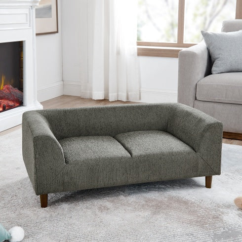 Dog approaching a new sofa bed during a calm introduction