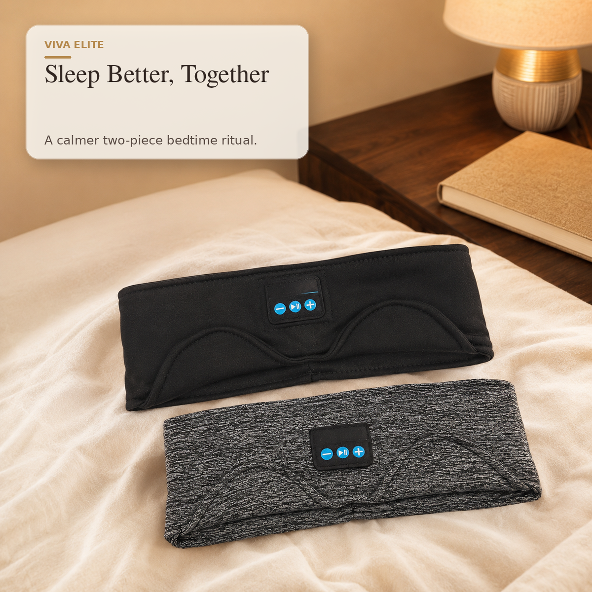 Two wearable sleep support headbands are displayed on a bed in a bedroom setting. The top headband is black and the bottom is heather gray, both with a small control panel on the front.