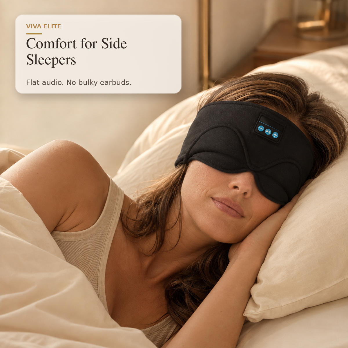 A woman lying in bed wearing a black sleep mask with a small blue LED control panel. A text overlay in the top left reads 'VIVA ELITE Comfort for Side Sleepers Flat audio.
