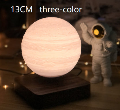 A 3D printed white moon lamp levitating above a wooden base, with a touch sensor on the side.