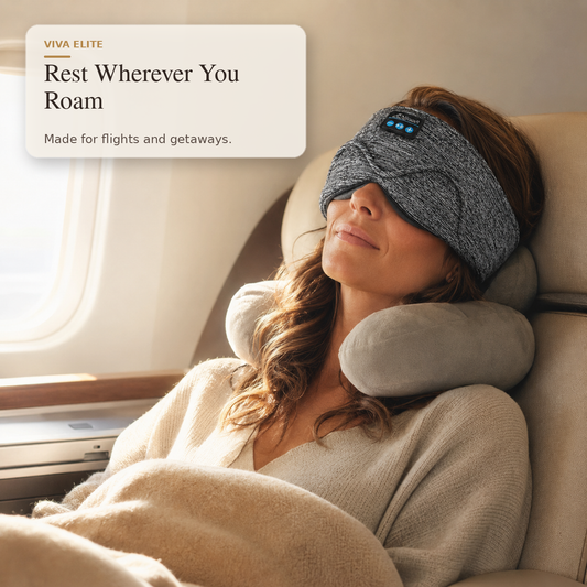 A woman reclining on an airplane seat with a gray knit sleep mask and matching neck pillow, with a text overlay reading 'VIVA ELITE Rest Wherever You Roam Made for flights and getaways.'.
