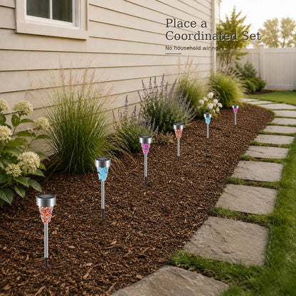 Coordinated placement of six solar stake lights in a garden