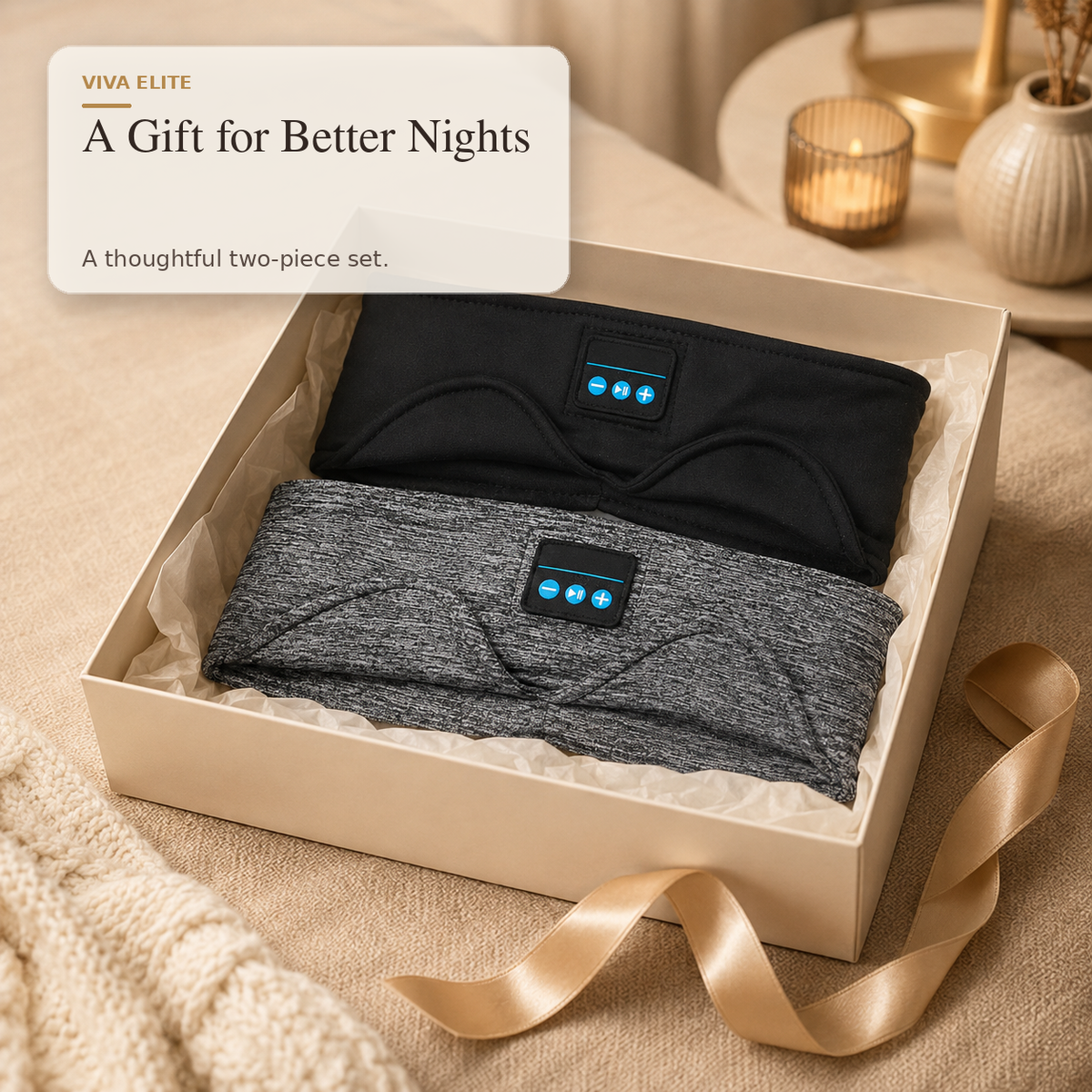 A gift box containing two wearable heating pads, one black and one heather gray, with a beige card that reads 'A Gift for Better Nights' and 'VIVA ELITE'.