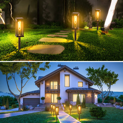 Garden pathway with solar lights and a house illuminated at night.