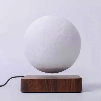 A 3D printed white moon lamp levitating above a wooden base, with a touch sensor on the side.