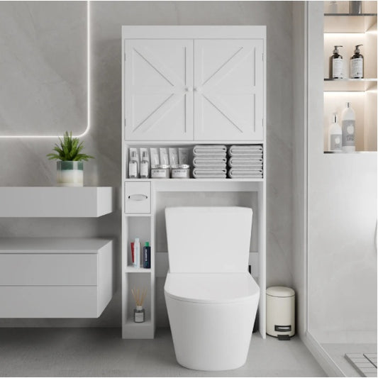 White over-the-toilet storage cabinet with two doors, featuring shelves with towels and bathroom accessories in a model bathroom setting.