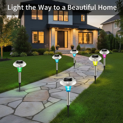 Solar-powered garden lights on a stone pathway leading to a house with decorative lighting.