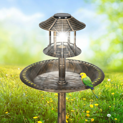 Solar-powered bird bath with a bird perched on it in a garden setting