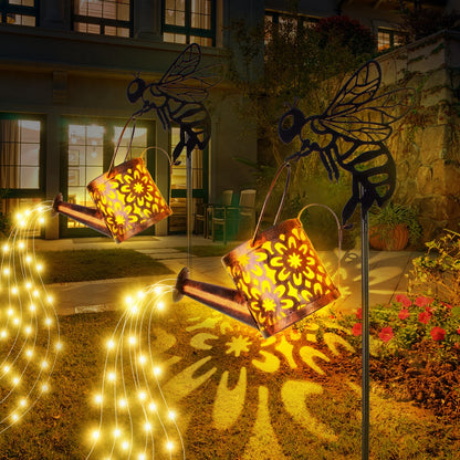 Decorative metal bees with lanterns and string lights in a garden setting.