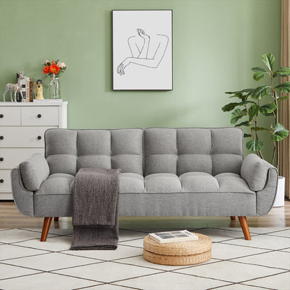A modern gray fabric sofa with a sleek silhouette, featuring cushioned backrest and seat, positioned in a room with light green walls and a wooden floor.