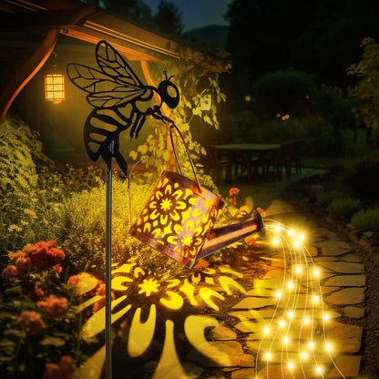 Decorative garden light with bee design and string lights in a garden setting
