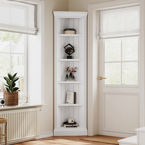 A white 5-tier corner bookshelf with various decorative items displayed on its shelves, placed in a bright room corner.