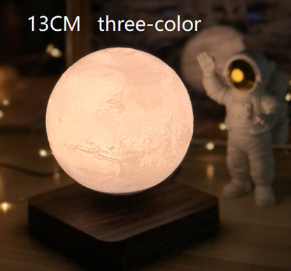 A 3D printed white moon lamp levitating above a wooden base, with a touch sensor on the side.