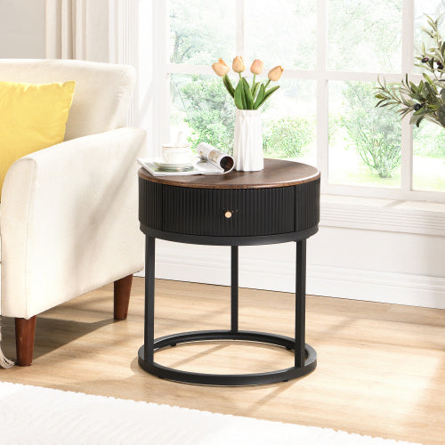 round black bedside table styled in a bedroom