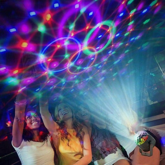 People enjoying a disco party with colorful lights and a disco ball.
