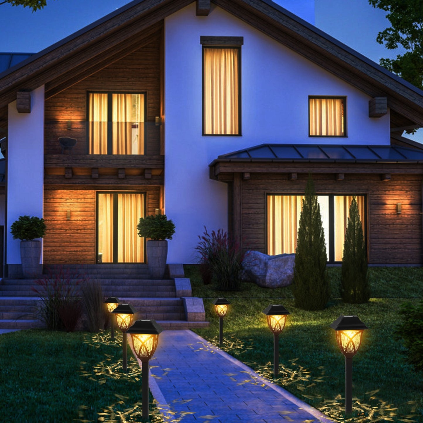 Modern house with illuminated windows and decorative outdoor lights at night.
