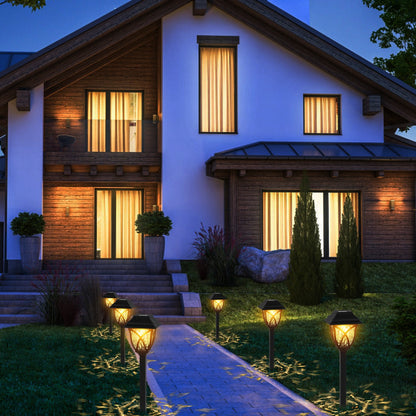 Modern house with illuminated windows and decorative outdoor lights at night.