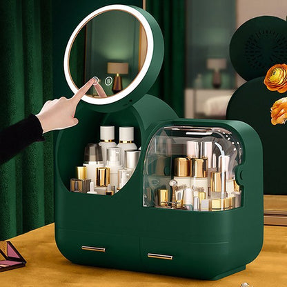 A green makeup case with LED mirror, featuring multiple compartments and dividers, with a person's hand adjusting the mirror.