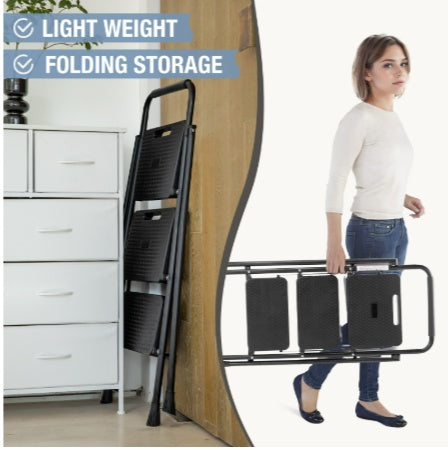 Woman using a folding storage solution with black bags on a cart in a room.