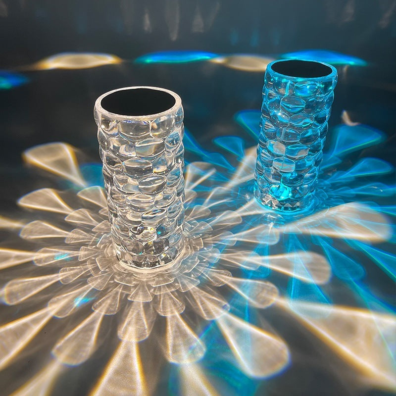 Two textured glass cups on a reflective surface with a dark background