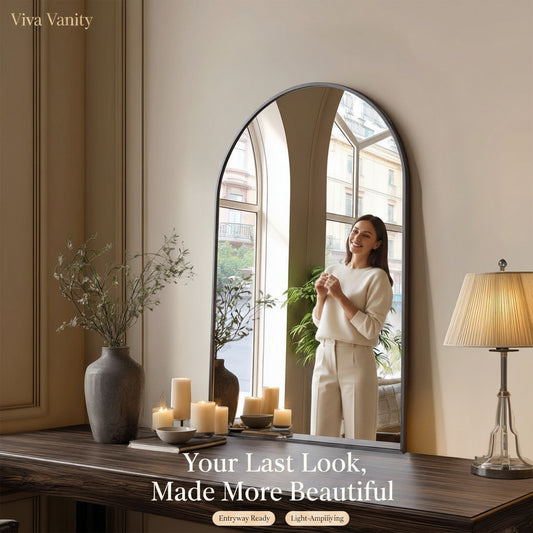 Arched mirror on a wooden console table with decorative items in a room.