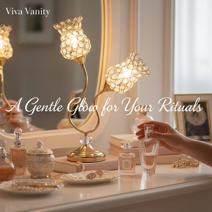Decorative table setting with candles, books, and a glass of water on a vanity mirror background.