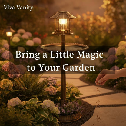 A bronze solar-powered bird bath with a LED light on top, situated on a pedestal with a basin for birds to bathe in, placed outdoors.