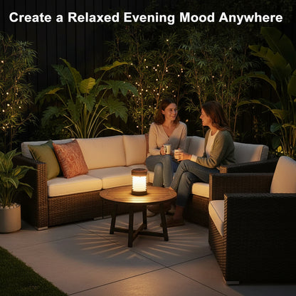 Two people sitting on a patio with outdoor furniture and lighting, creating a relaxed evening mood.