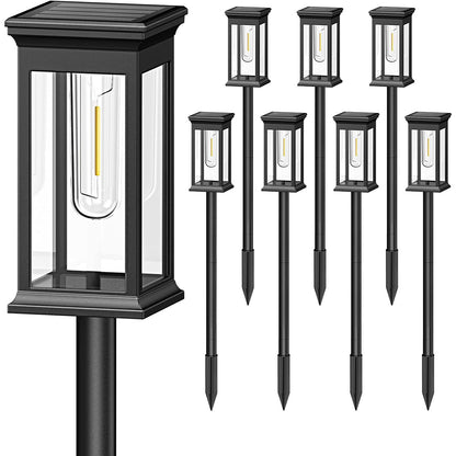 Set of black outdoor post lights and solar-powered pathway lights on a white background