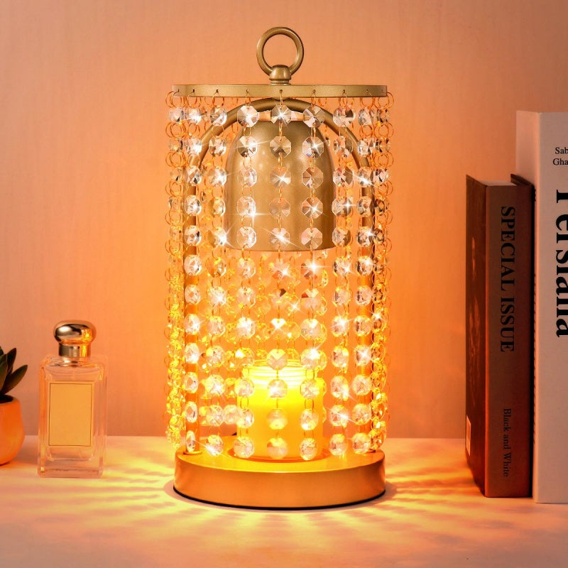 Decorative lamp with beaded design on a table next to a book and a plant