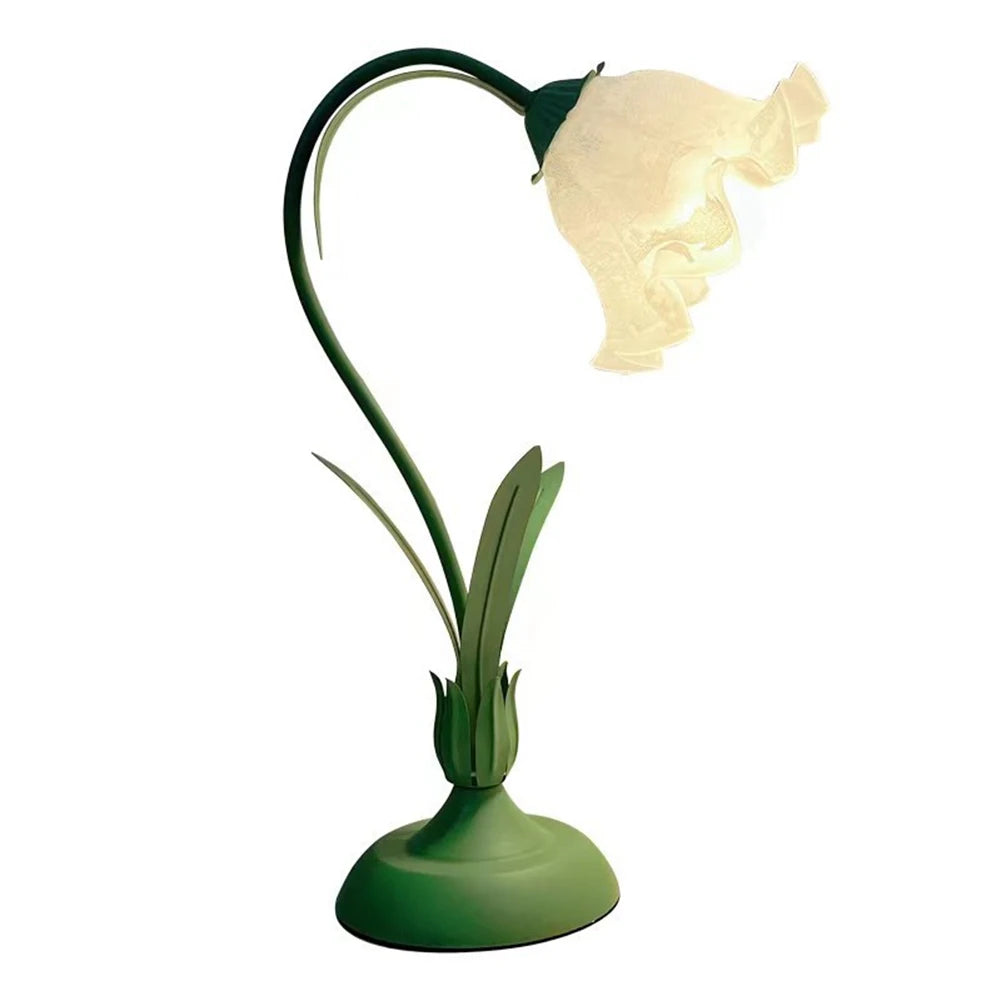 Decorative lamp shaped like a flower with a green base on a white background