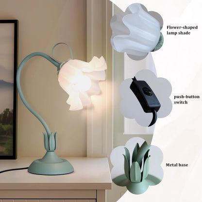 Desk lamp with flower-shaped lampshade on a table, showing close-up details.