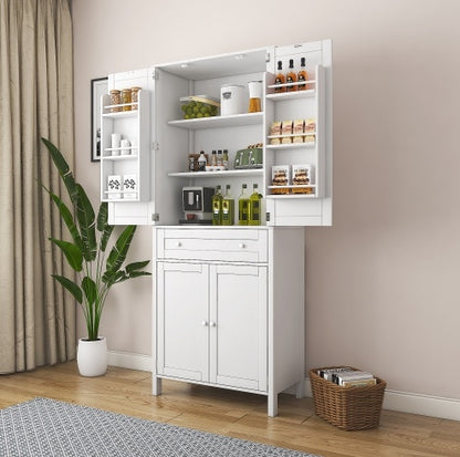 A tall white kitchen pantry cabinet with two doors open, displaying shelves with food items and kitchen utensils. The cabinet is placed in a home setting with a plant and a woven basket on the floor.