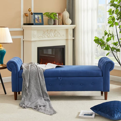 Navy blue rectangular sofa stool with multifunctional storage, featuring button tufted details and curved armrests, placed in a room with a fireplace and decorative items.