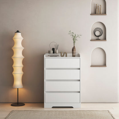 A white handleless dresser with four drawers placed in a room with a minimalist design, featuring a floor lamp and decorative items on the top surface.