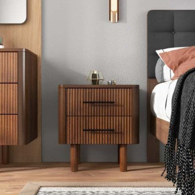 Wooden nightstand with two drawers in a bedroom setting.