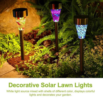 Decorative solar lawn lights in a garden setting with colorful shell designs.
