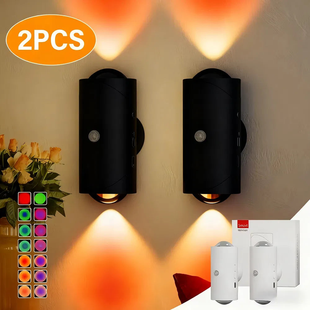 Two black wall lights on a wall with a color swatch and two white devices below.