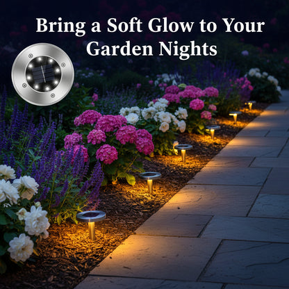 Solar-powered garden lights illuminating a pathway with flowers at night.