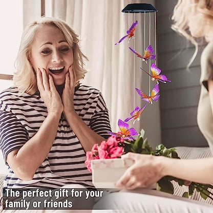 Woman receiving a colorful butterfly wind chime as a gift