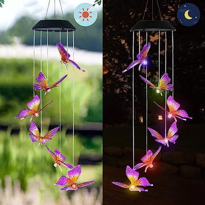 Butterfly-shaped solar wind chime with LED lights, shown outdoors during the day and night.