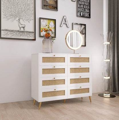 A white color 8-drawer chest of drawers with rattan drawer faces and golden legs and handles, placed in a room with a variety of decorations.