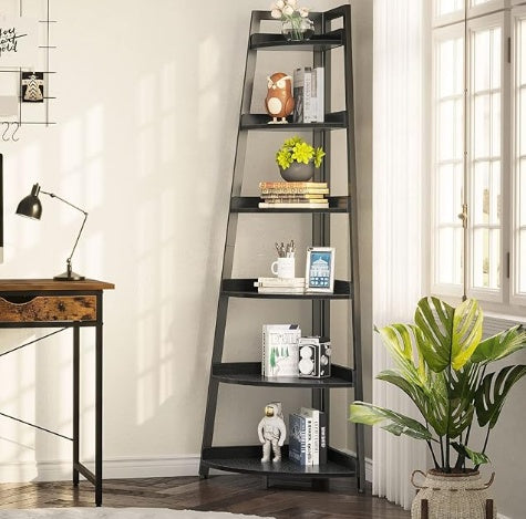 A 6-tier corner bookshelf with a black frame and beige shelves, featuring various decorative items on each shelf, placed in a home setting near a window and a desk.