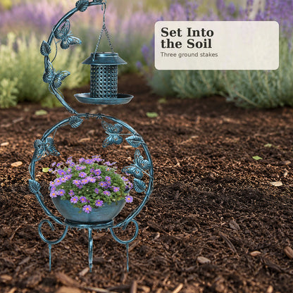 Three ground stakes set into soil for the antique blue bird bath