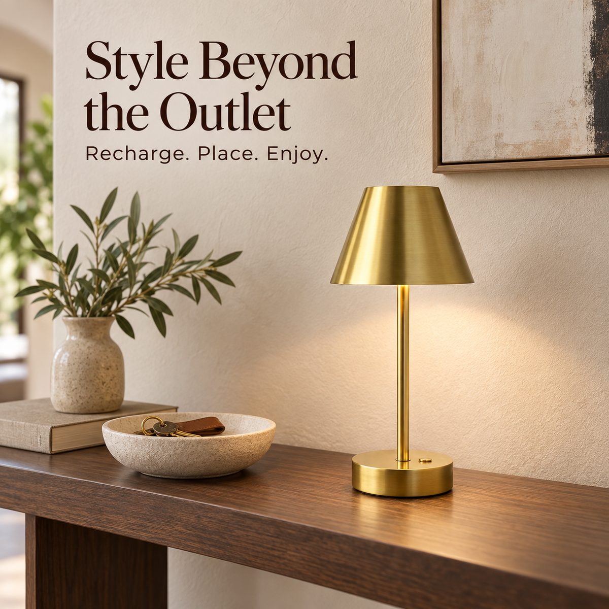Cordless brass table lamp on a walnut entryway console with a ceramic key bowl.