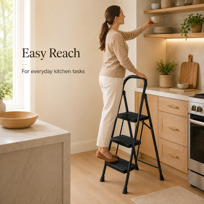 Woman using a matte black three-step folding ladder in a kitchen